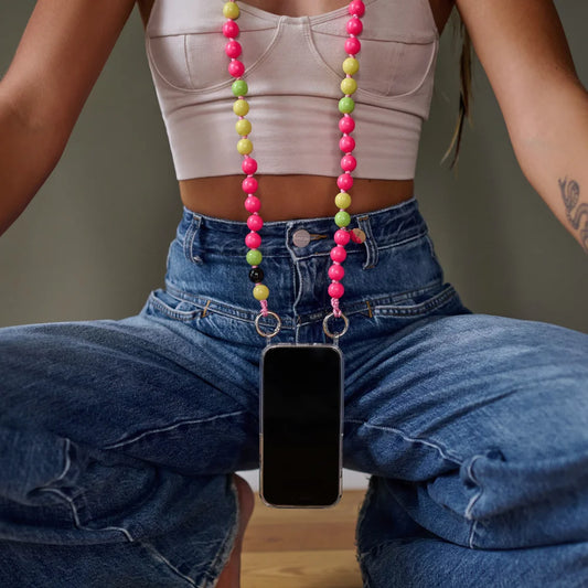 flashdance cellphone chain with case upbeads worn as a necklace size is 120cm crossbody pink and yellow and lime colors worn on a model blue jeans and white top