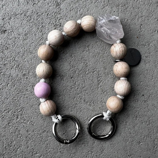 natural wooden upbeads on creme white cord with one rose quarz crystal