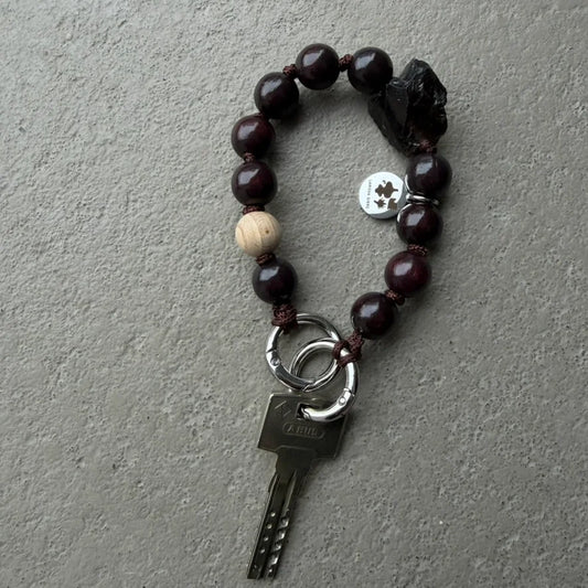 smokey chocolate quarz mini upbeads in collaboration with larissa giers. dark brown beads with smokey quarz and a natural wooden bead as signature on dark brown cord