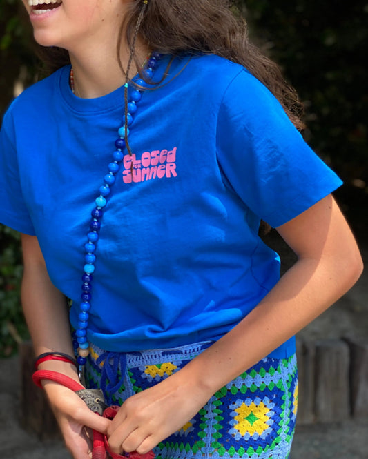 AQUA cell phone chain CROSSBODY UPBEADS girl laughing wearing blue t-shirt and upbeads aqua crossbody