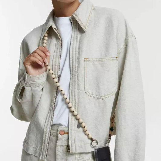 upbeads crossbody cellphone chain on woman dressed in white jeans and white closed jeans jacket crossbodyupbeads crossbody cellphone chain on woman dressed in white jeans and white closed jeans jacket crossbody