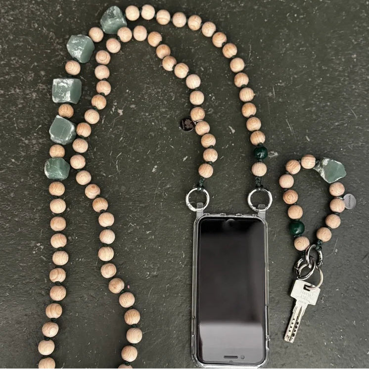 upbeads beaded cellphone chain and keychain on a dark surface