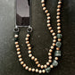 upbeads wooden bead chain a a phone chain on a dark surface