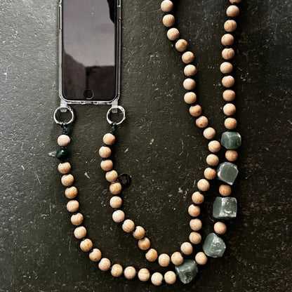 upbeads wooden bead chain a a phone chain on a dark surface