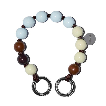 Beaded upbeads mini Vanilla Bean bracelet with circular metal clasps on a white background