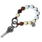 Beaded Vanilla Bean Mini upbeads bracelet with a key charm on a white background