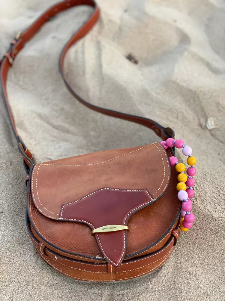 upbeads candy in a leather bag from isabel marrant on the beach