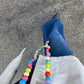 confetti upbeads looking down to the street and colorfull pastel beads chain