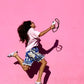 midi junglebeads upbeads attached to ipone while girl jumps with pink background