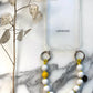 LAVAN YELLOW MINI PENDANT MINI UPBEADS on white marble with phone case