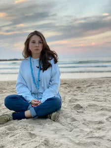 THE EYE MIDI cell phone chain / key chain MIDI UPBEADS girl sitting at the beach in Tel Aviv wearing upbeads midi the eye light blue as a key chain