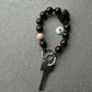 smokey chocolate quarz mini upbeads in collaboration with larissa giers. dark brown beads with smokey quarz and a natural wooden bead as signature on dark brown cord