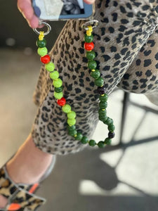 sue blond holding a shortie upbeads wooden bead chain green and orange lime combination