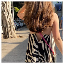 Load image into Gallery viewer, LOVE cell phone chain CROSSBODY UPBEADS girl in sundress walking in Tel Aviv wearing upbeads love phone and key chain pink and orange