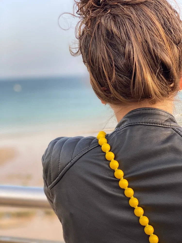 crossbody upbeads yellow beads pink signature beads rolled up product shot wooden beads handmade yellow beach sand portugal
