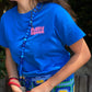 AQUA cell phone chain CROSSBODY UPBEADS girl laughing wearing blue t-shirt and upbeads aqua crossbody