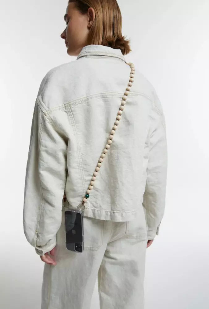 upbeads crossbody cellphone chain on woman dressed in white jeans and white closed jeans jacket crossbody