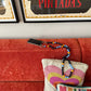 FOOFI cell phone chain CROSSBODY UPBEADS on designer sofa matching with colouful pillows and Aaron Rose art pieces