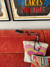 Load image into Gallery viewer, FOOFI cell phone chain CROSSBODY UPBEADS on designer sofa matching with colouful pillows and Aaron Rose art pieces