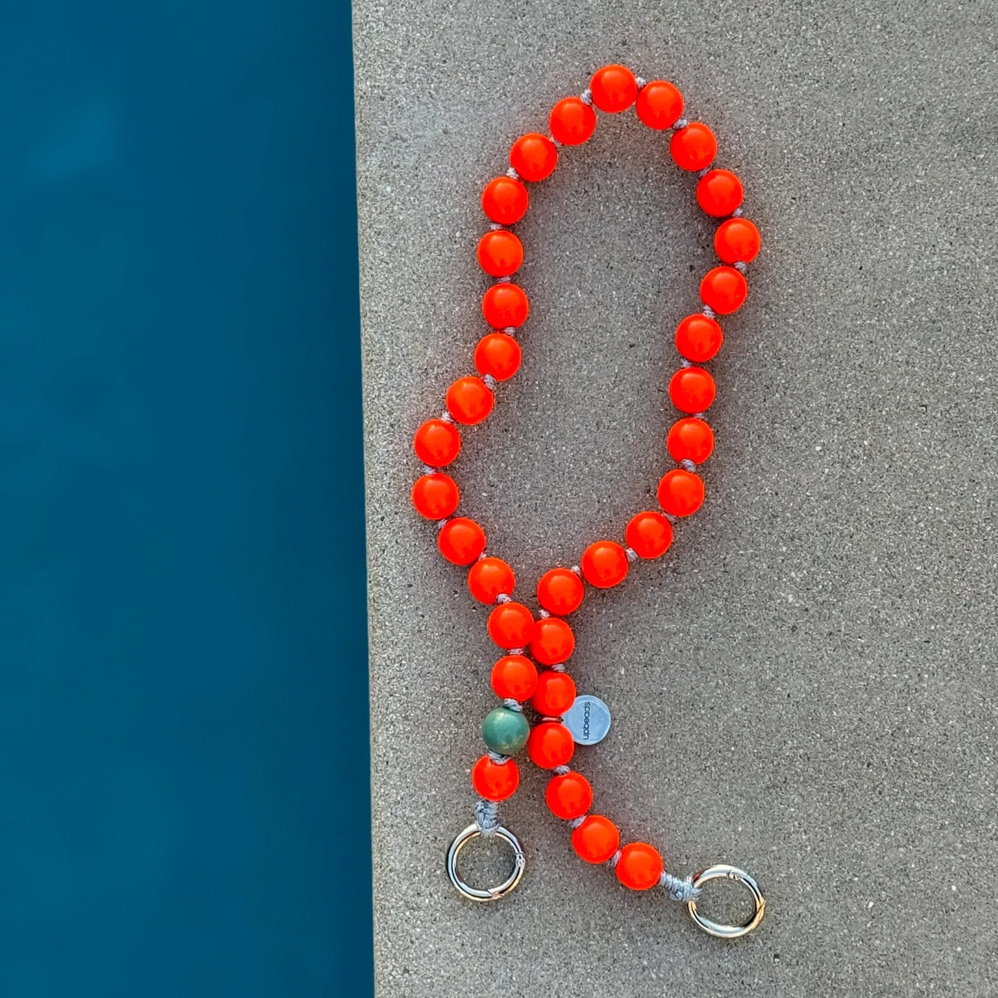 foxy upbeads neon orange cellphone chain and keychain at the pool