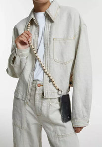 upbeads crossbody cellphone chain on woman dressed in white jeans and white closed jeans jacket crossbodyupbeads crossbody cellphone chain on woman dressed in white jeans and white closed jeans jacket crossbody