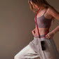 model Sina is wearing a crossbody simply red upbeads cellphone chain while practising yoga
