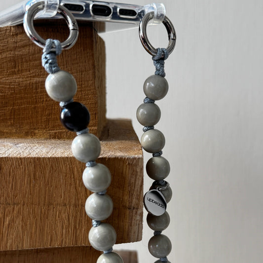 upbeads earl grey crossbody beige wooden beads with dark brown signature wooden bead attached to a cellphone case