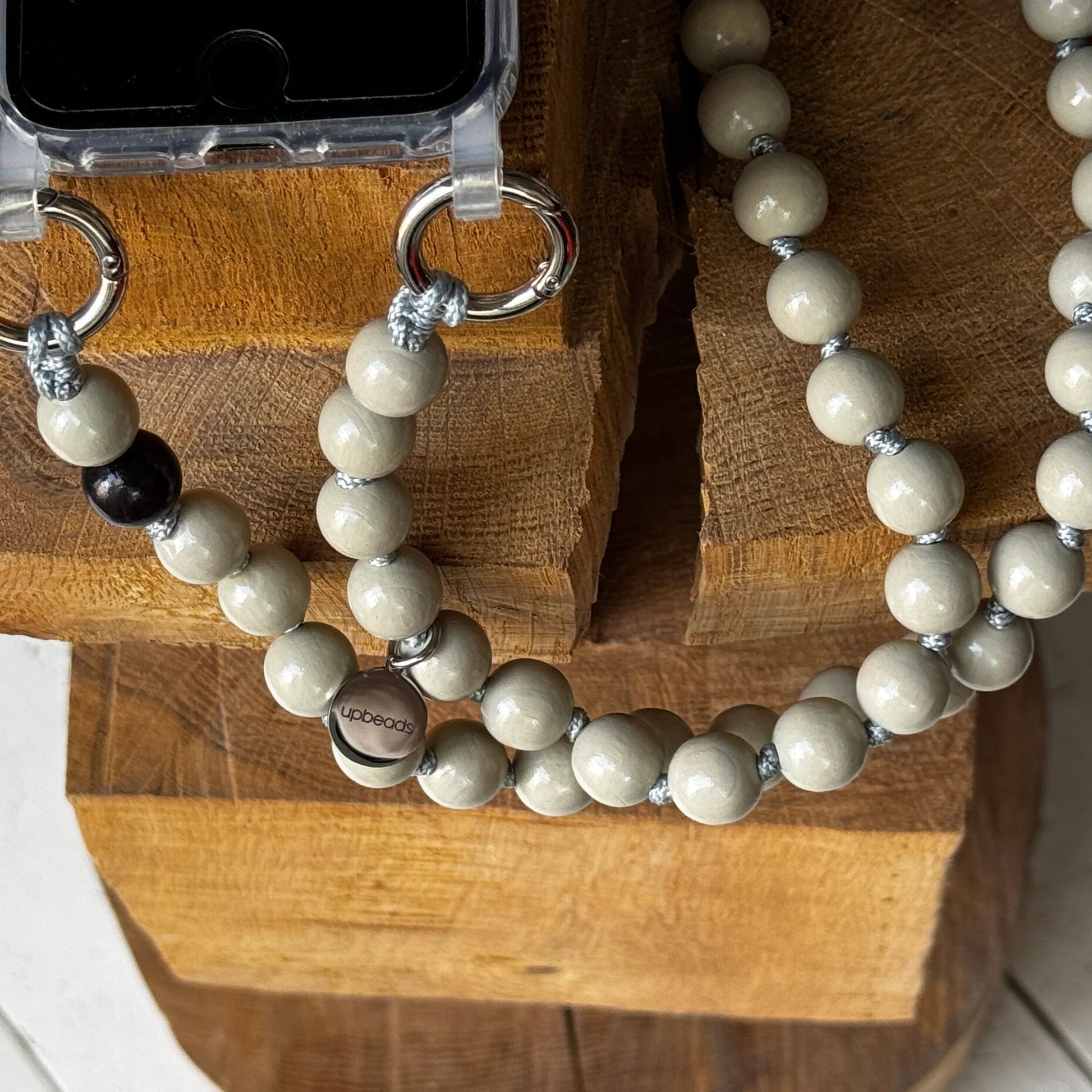 upbeads earl grey beige wooden beads crossbody attached to a cellphone case