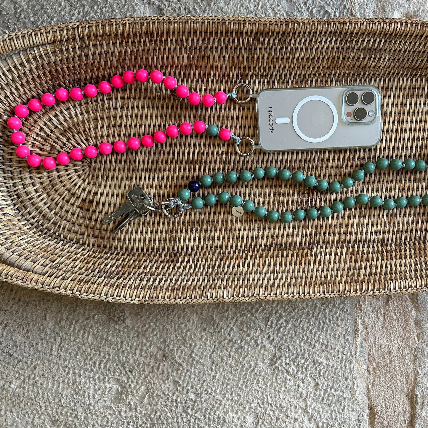 2 models of upbeads shortie size pink lady in neon pink as a cellphone chain and sage green as keychain