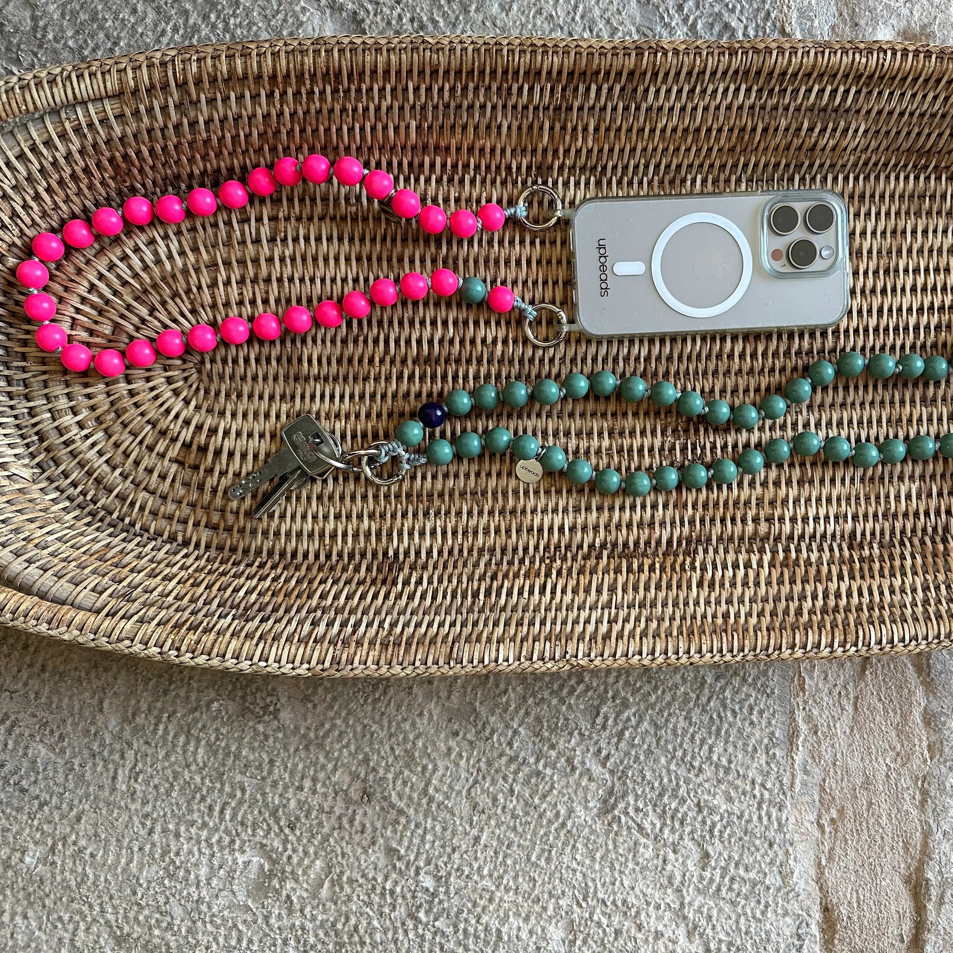 2 models of upbeads shortie size pink lady in neon pink as a cellphone chain and sage green as keychain